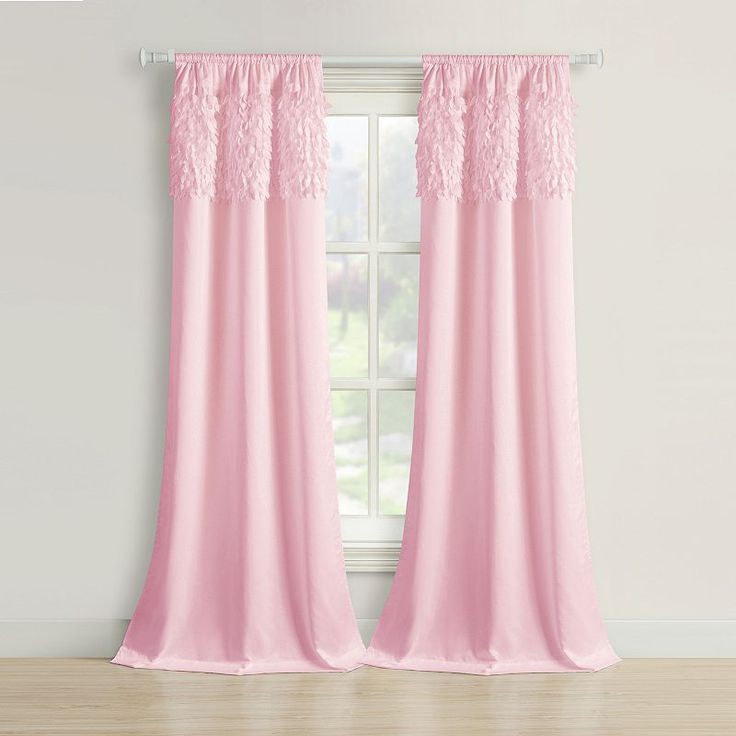 pink curtains with lace trims hanging on a window sill in front of a white wall