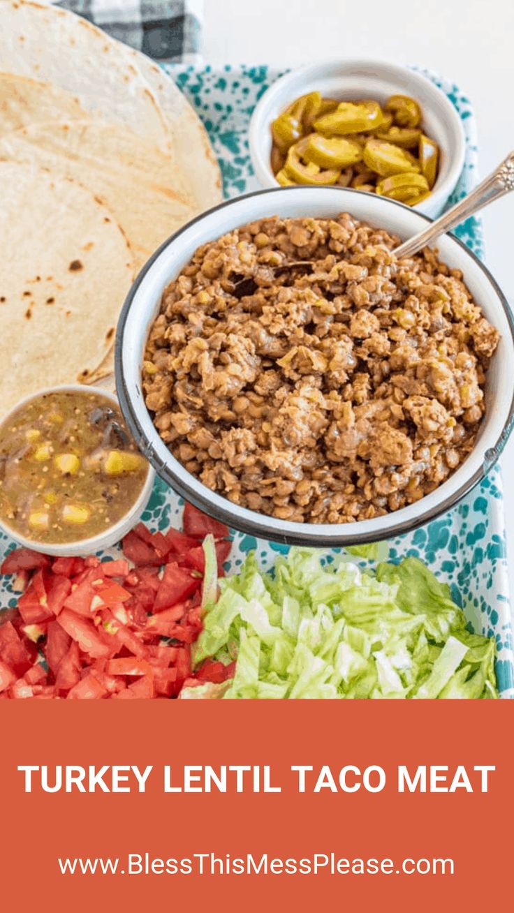 turkey lentil taco meat in a white bowl with lettuce, tomatoes and jalapenos