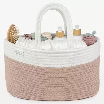 a white and pink basket with some items in it