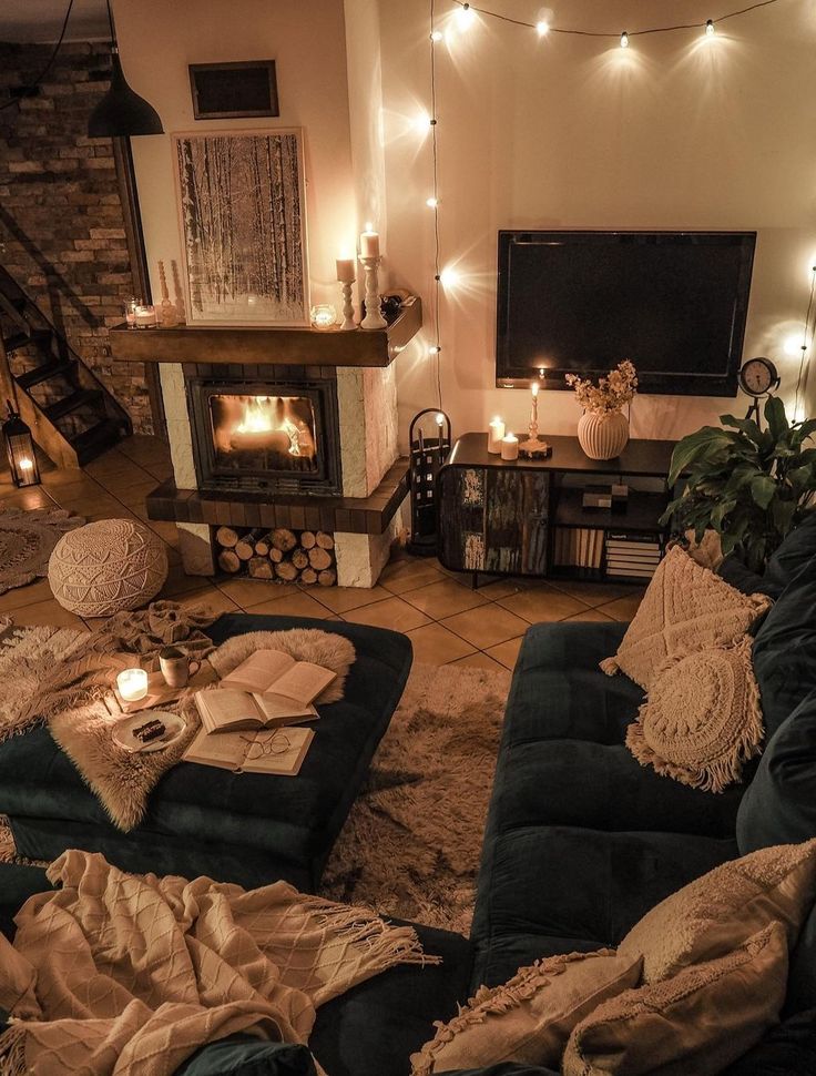 a living room filled with lots of furniture and lights on the wall above it's fireplace