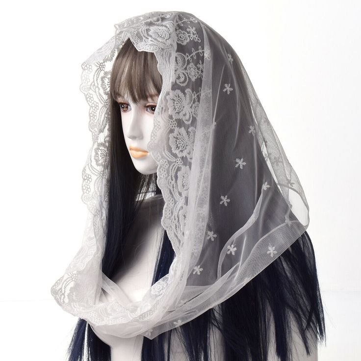 a mannequin head wearing a veil with flowers on it