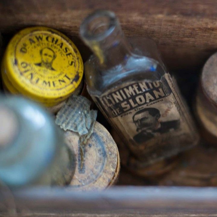 an old wooden box filled with glass bottles