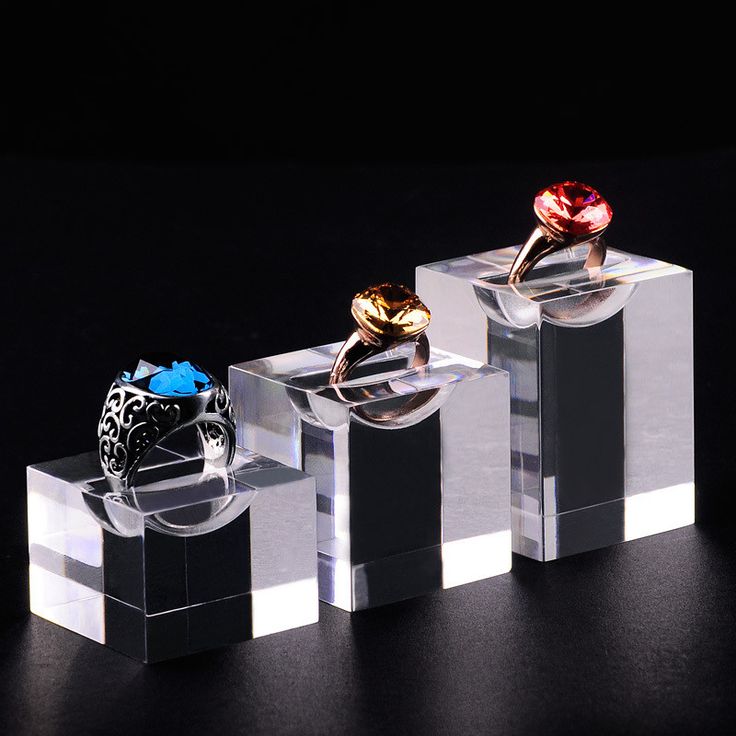 three rings sitting on top of each other in acrylic blocks with black background