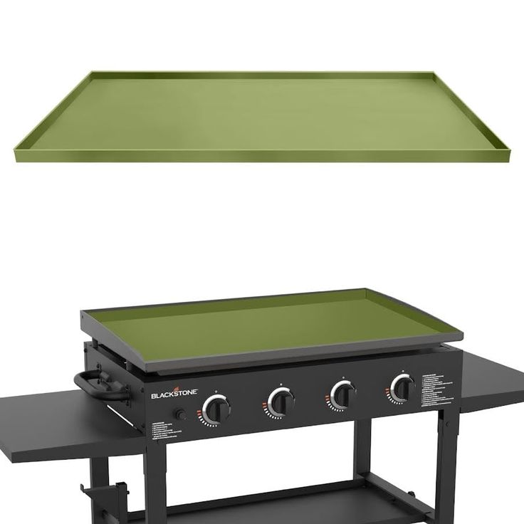 an outdoor grill with a green cover over it's burner and shelf for cooking