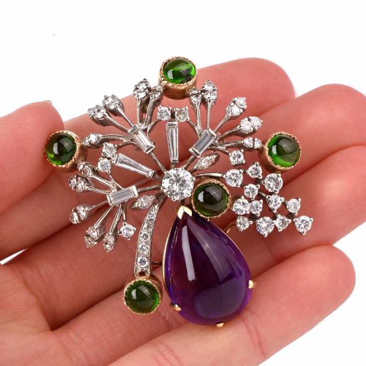 "This aesthetically alluring Retro vintage brooch pin is crafted in a solid 14K white and yellow gold, the latter applied to colored gemstones settings. It weighs 22.5 grams and measures 2 long x 1.9\" wide. This eye-catching Retro brooch is centered by one round diamond 0.78ct, complemented by some 55 round-faceted diamonds of varying sizes, 5 baguette diamonds and two marquise diamonds all approx. 3.10 cts H-I color, VS clarity approx. A prominent pear-shape amethyst cabochon 18.50 cts and 5 r Formal Round Brooches With Single Cut Diamonds, Diamond Brooches With Brilliant Cut In Fine Jewelry Style, Round Single Cut Diamond Brooches, Diamond Brooch With Brilliant Cut, Formal Multi-stone Brooch In Fine Jewelry Style, Fine Jewelry Diamond Brooch With Brilliant Cut, Classic Diamond Gemstone Brooches, Formal Multi-stone Brooches In Fine Jewelry Style, Classic Diamond Brooch With Gemstones