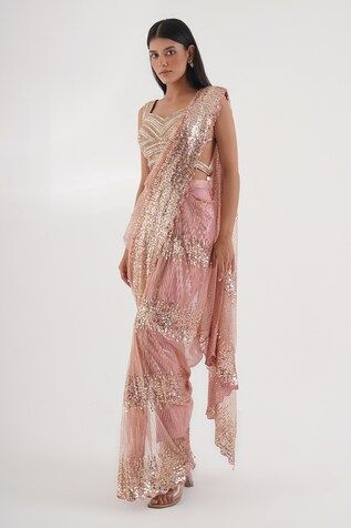 Pink pre-draped pant saree with sequin cluster embellished base and bead tassels. Comes with nalki embroidered padded blouse embellished by beads and stones. - Aza Fashions Festive Draped Sequin Dupatta, Sequined Draped Dress For Diwali, Draped Sharara With Mirror Work For Diwali, Diwali Sharara With Mirror Work And Draped Style, Pink Embellished Pre-draped Saree For Navratri, Embellished Pink Pre-draped Saree For Navratri, Fitted Pre-draped Saree With Sequins For Diwali, Sequined Draped Lehenga, Pink Saree With Mirror Work