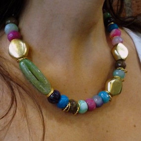 "This is a stunning statement necklace. Colorful tones agate stones create a very unique piece. Three 18k gold plated nuggets give an asymmetric modern look. Agate's most noticeable properties overall are balancing yin/yang energy, courage, protection, healing, and calming. Historically it was placed in water for cooking or drinking to dispel sickness. The Metaphysical and Healing Properties Lore of any specific type of agate depend to some extent on the color of the agate, but all agates have c Fuchsia Necklace, Gold Stone Necklace, Necklace Stones, Red Stone Necklace, Agate Stone Necklace, Multicolor Necklace, Open Wings, Eagle Pendant, Red Coral Necklace