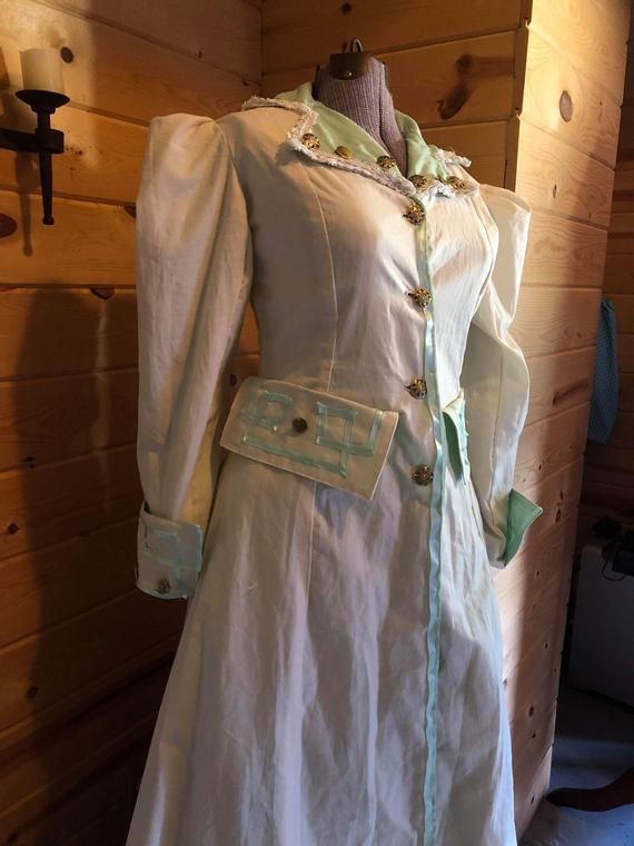 Custom made upon order. This cotton coat is perfect for any Victorian, Edwardian or Steampunk event. It comes with one petticoat of the same color as the trim. Coat colors and trim can be changed on request. Comes in size 4-24 No refunds or exchanges.Please include your measurements in the buyer's comments upon ordering. Fitted Steampunk Victorian Costume Dress, Fitted Steampunk Victorian Dress For Costume, Steampunk Victorian Dress Fitted For Costume, Regency Style Fitted Long Sleeve Outerwear, Victorian Long Sleeve Dress With Buttons, Regency Style Long Sleeve Costume Outerwear, Spring Victorian Costume Dress With Historical Design, Spring Victorian Dress Costume With Historical Design, Spring Victorian Dress With Historical Design For Costume