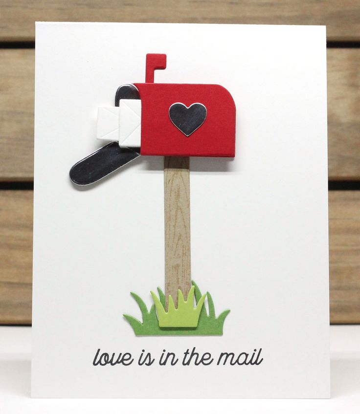 a handmade card with a red mailbox and heart on the top that says love is in the mail