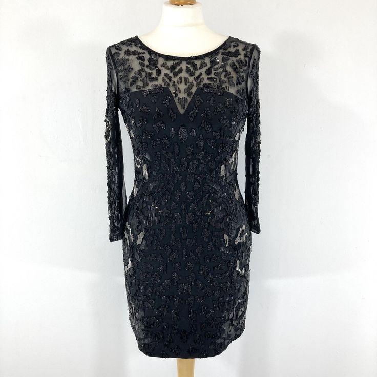 Stunning beaded midi dress by AllSaints in heavily embellished sheer black fabric. The dress a large amount of beading on the front and back, with high quality heavy weight beads and sequins that catch the light when the dress moves. It has a sheer panel on the back with a symmetrical beaded pattern Zip fastening.  In good condition, with a few unnoticeable missing beads. Measurements  Bust: 32" Waist: 28" Length: 32" Sleeves: 17" Festive Embellished Glamorous Midi Dress, Glamorous Embellished Festive Midi Dress, Embellished Midi-length Party Evening Dress, Festive Embellished Midi Evening Dress, Evening Party Embellished Midi Dress, Glamorous Sheer Midi Dress For Cocktail, Evening Embellished Midi Party Dress, Embellished Midi Dress For Evening Party, Festive Party Dress With Sheer Sleeves