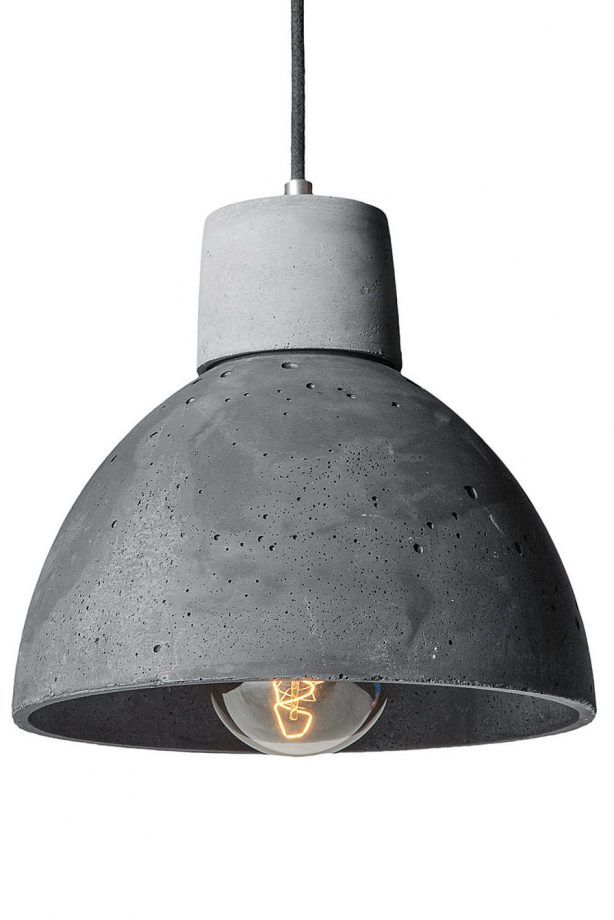 an industrial style light fixture hanging from a metal ceiling lamp with a concrete finish on it