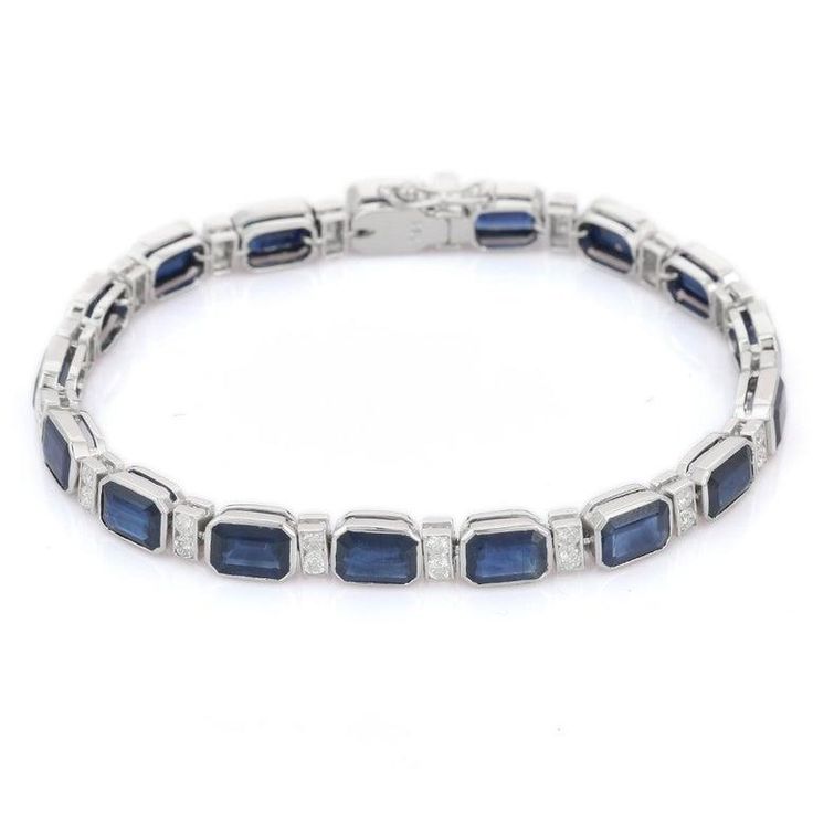 Blue Sapphire and Diamond bracelet in 18K Gold. It has a perfect octagon cut gemstone to make you stand out on any occasion or an event. A tennis bracelet is an essential piece of jewelry when it comes to your wedding day. The sleek and elegant style complements the attire beautifully, whether it's the bride wearing it herself, or as a gift to her bridesmaids to wear on the D’day.  Bracelets are worn to enhance the look. Women love to look good. It is common to see a woman rocking a lovely gold bracelet on her wrist. A gold gemstone bracelet is the ultimate statement piece for every stylish woman.  PRODUCT DETAILS :-  > Material - 18K Solid White Gold > Gemstone - Blue Sapphire  > Stone Weight - 17.85 ct > Stone Shape - Octagon  > Stone Pcs - 17  > Stone Size - 7 x 5 mm > Diamond Weight - Fine Jewelry White Gold Rectangular Tennis Bracelet, Blue Diamond Cut Bracelet For Formal Occasions, Rectangular Diamond Bracelet In Fine Jewelry Style, Rectangular Diamond Bracelets In Fine Jewelry, Formal White Gold Tennis Bracelet With Rectangular Shape, Luxury Sapphire Bracelet For Formal Occasions, Formal Blue Diamond-cut Bracelet, Formal Blue Diamond Cut Bracelet, Formal White Gold Rectangular Tennis Bracelet