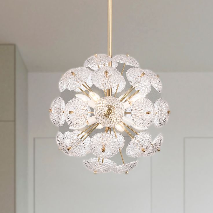 a chandelier hanging from the ceiling in a room with white walls and doors