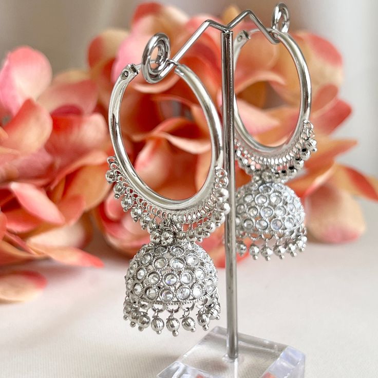 "These silver-plated polki chandbali jhumka hoop earrings are a stunning addition to any outfit. The intricate detailing and beautiful silver beads add an elegant touch to this Bollywood inspired piece, while polki stones give it a gorgeous glimmering sparkle. Length 2.3\" | Width 1.5\" Items are carefully packed and ready for gifting. All pictures are taken in natural light please allow for slight variations in color due to camera settings. Jewelry Care ✨Protect your jewelry in a closed box or pouch   ✨Wear jewelry after you have applied lotion or perfume ✨Gently buff with a soft cotton cloth  Visit our website: www.desimoon.etsy.com Thank you for visiting and hope you enjoy my shop!" Intricate Design Hoop Earrings For Wedding, Silver Hoop Earrings For Festivals With Intricate Design, Silver Metal Chandbalis For Wedding, Festival Silver Hoop Earrings With Intricate Design, Eid Chandbali Bridal Earrings, Traditional Festive Metal Hoop Earrings, Heavy Temple Jewelry Hoop Earrings, Traditional Metal Hoop Earrings For Celebration, Silver Metal Chandbalis For Festive Occasions