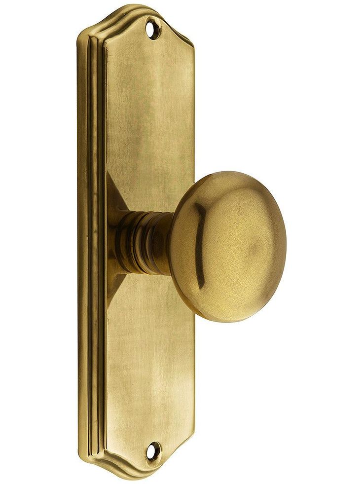 an antique brass door handle on a white background