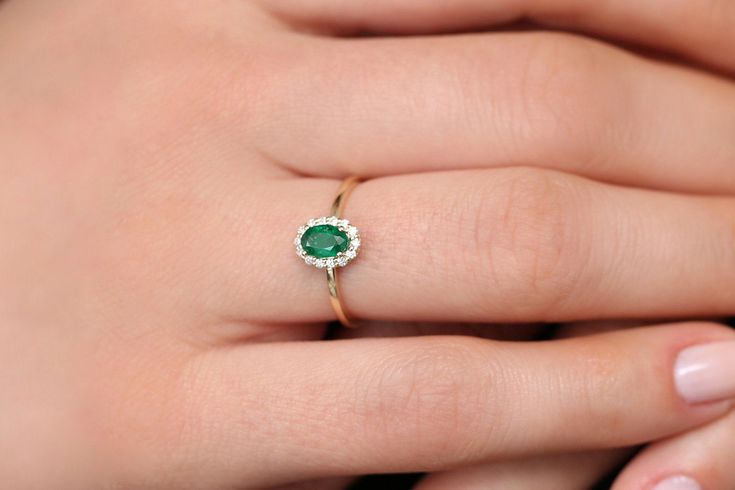 "Emerald Ring / 14k Classic Oval Cut Emerald Ring with Surrounding Diamonds / Natural Emerald Ring in 14k Solid Gold / Mothers Day Gift * If you would like to see the Matching Earrings Please Click Below https://www.etsy.com/listing/604292239/emerald-earrings-14k-oval-cut-emerald?ref=related-4 * If you would like to see the Matching Necklace Please click Below https://www.etsy.com/listing/590436480/emerald-necklace-14k-classic-oval-cut?ref=related-1 Item Features * Made to Order. * Gold KT: 14K Dainty Oval Ring With Halo Setting, Dainty Oval Halo Setting Rings, Dainty Oval Rings With Halo Setting, Dainty Oval Halo Rings, 14k Yellow Gold Cluster Ring With Oval Shape, Oval Yellow Gold Emerald Ring With Halo, Oval Birthstone Ring Fine Jewelry, Dainty Oval Emerald Ring For Anniversary, Dainty Oval Diamond Ring For Anniversary