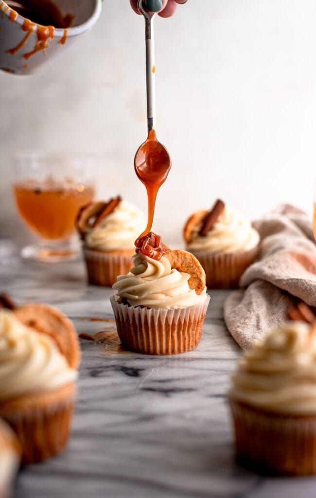 cupcakes with icing being drizzled onto them