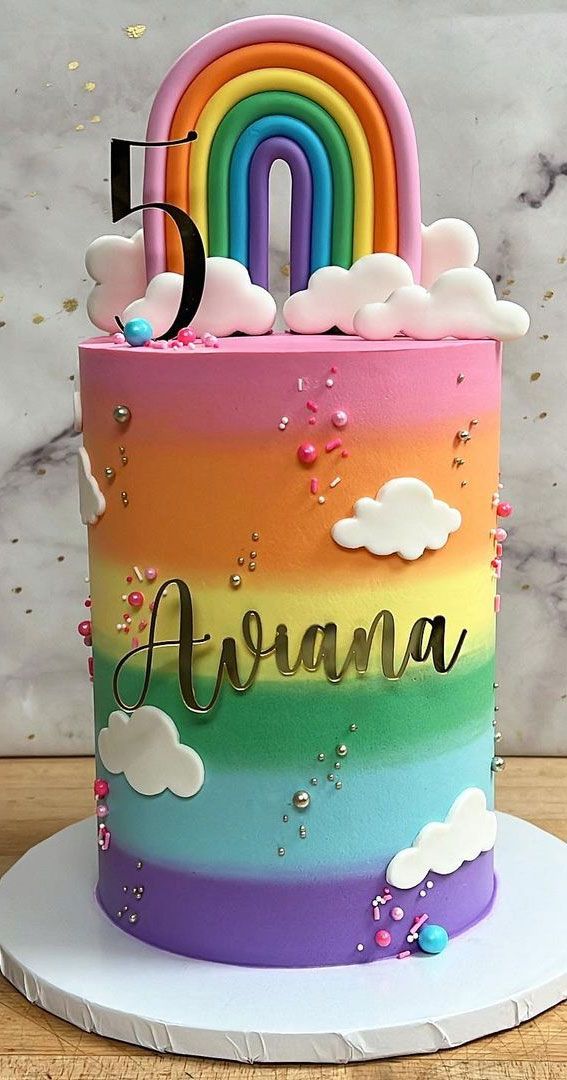 there is a rainbow cake with clouds and a number on it that says avana