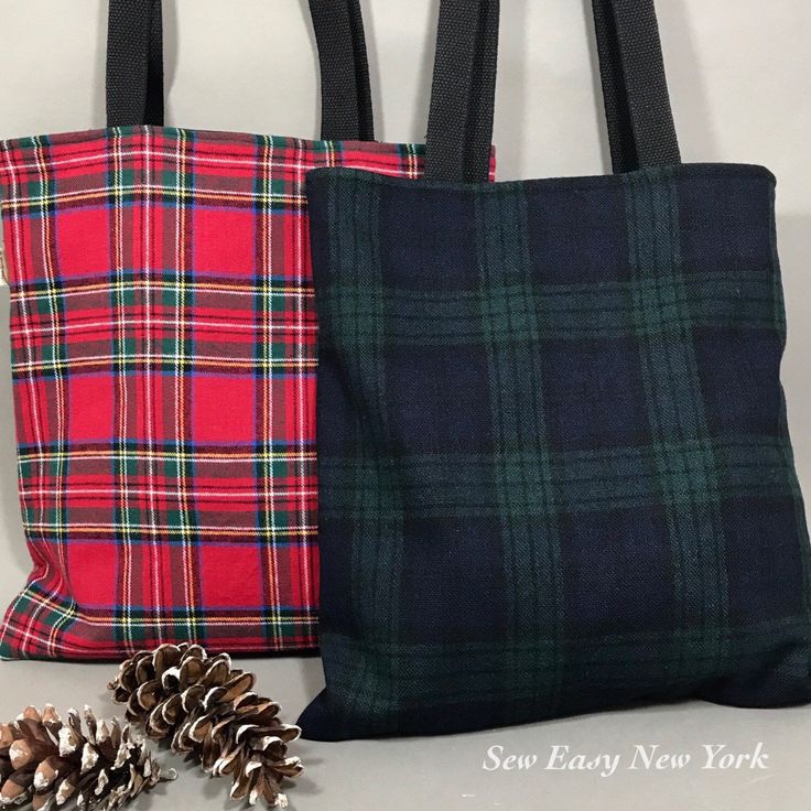 two plaid totes with pine cones on the side and one in red, black and green