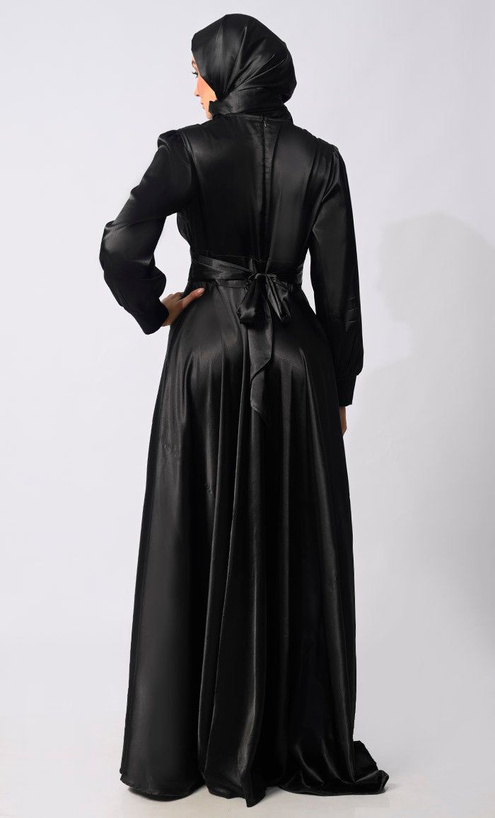 Introducing our exquisite Lycra Satin Flared Abaya, a stunning fusion of elegance and contemporary style. Crafted with meticulous attention to detail, this abaya is designed to elevate your modest fashion wardrobe to new heights. The flared silhouette adds a touch of graceful movement, enhancing the overall allure of the garment. Featuring a front draped pleated style, which adds texture and dimension, creating visual interest and a unique focal point. Complementing the pleats are satin show buttons, delicately embellishing the front of the abaya for a refined finish. For added versatility and cinched-in definition, an attached belt accompanies the abaya, allowing you to adjust the fit according to your preference and accentuate your waistline. The back zipper closure ensures a seamless an Graceful Movement, Abayas Fashion, Black Satin, Satin Dresses, Modest Fashion, Focal Point, Contemporary Style, Satin, Couture