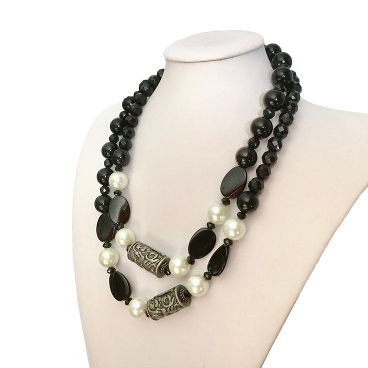 Black onyx, black crystals, flat agate beads, white glass pearls and silver beads, gemstones necklaces. Can be worn long or short. Strung on a professional quality beading wire. Arrives in a gift box. * Handcrafted necklace * Long Necklace Length: 41 inches long * Short Necklace Length: 20.5 inches long * This is one of a kind necklace. Two ways to wear it, long or short. Elegant Onyx Beads For Jewelry Making, Elegant Double Strand Beaded Necklace With Black Beads, Elegant Pearl Necklace With Faceted Oval Beads, Elegant Black Onyx Beads, Elegant Double Strand Beaded Necklace With Large Beads, Elegant Double Strand Faceted Beads, Elegant Onyx Black Beads, Elegant Black Large Beads, Elegant Black Beaded Necklace With Silver Beads