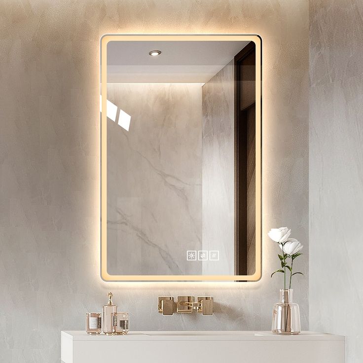 a bathroom with a sink, mirror and vase on the counter top in front of it