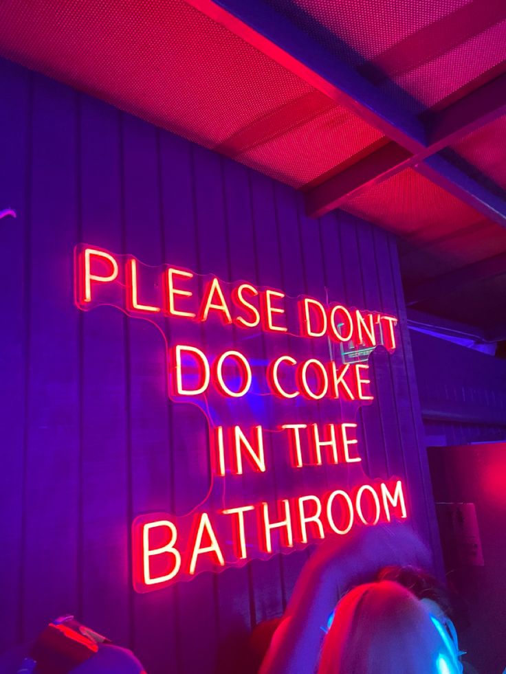 a neon sign that says, please don't do cake in the bath room