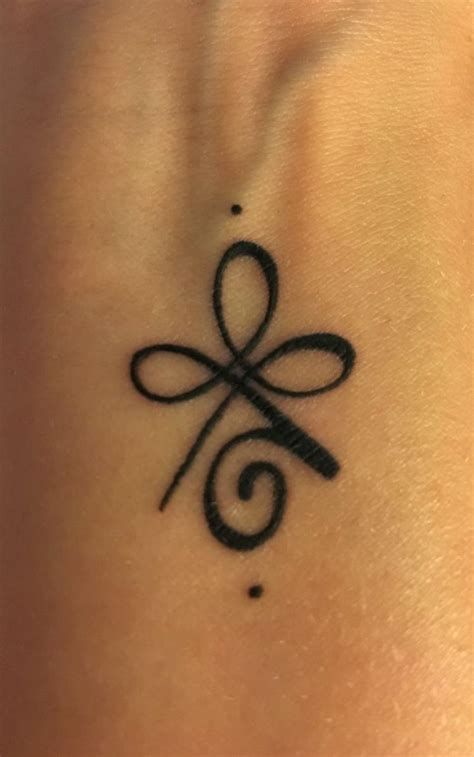 a black tattoo on the back of a woman's neck with an infinite symbol