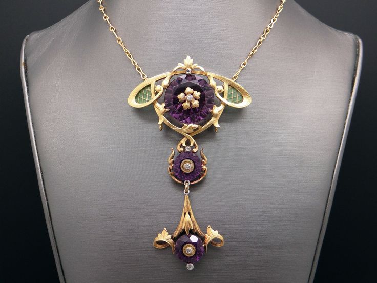 Jewelry Type: Plique A Jour Necklace ( Excllent Condition) Metal: 14k Yellow Gold Measurements: 3 3/4 inches x 2 inches (center section) 20 inch (length of chain) Markings: None Weight: 41.7 grams Main Stone: 3 Round Amethyst Color: Purple Measurement: A) 22mm x 11mm 20cts approx B) 12mm x 7mm 3cts approx C) 12mm x 7mm 3cts approx Gem Weight: 26ct approx Accent Stones: 6 matching Round Rose Cut Diamonds Color: I Clarity: SI-1 Gem Weight: 0.06ct approx. #12383 Luxury Purple Pendant Necklace, Luxury Amethyst Multi-stone Necklace, Luxury Multi-stone Amethyst Necklace, Elegant Purple Multi-stone Necklaces, Elegant Purple Multi-stone Necklace, Luxury Purple Cabochon Jewelry, Luxury Yellow Gold Amethyst Necklace, Luxury Purple Jewelry For Collectors, Luxury Multi-stone Purple Jewelry