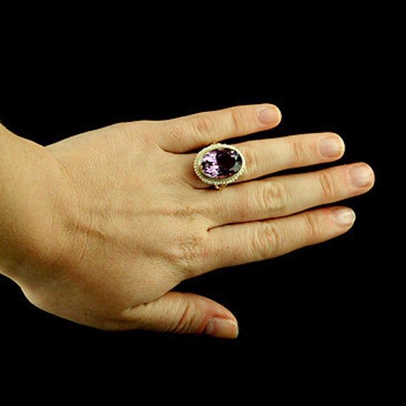 Amethyst Ring Victorian Style Cocktail Large Oval Seed Pearls Yellow Gold Bezel Set Gemstone There is nothing subtle and delicate about this ring. Flashy, expensive looking ring made of 14K yellow gold with a luxurious looking, large, oval amethyst (approximately 12ct) set in bezel and surrounded by a halo of gold twisted wire and oriental seed pearls. Sizes: 4-8 (smaller and larger sizes are available as custom orders.) PROUDLY MADE FROM SCRATCH IN NEW YORK CITY. Please allow 2-3 weeks to compl Formal Amethyst Oval Cabochon Ring, Oval Amethyst Ring With Gemstone Accents For Formal Occasions, Luxury Oval Amethyst Diamond Ring, Luxury Oval Amethyst Ring With Prong Setting, Luxury Oval Ring With Gemstone Accents, Oval Cabochon Amethyst Ring For Anniversary, Amethyst Oval Cabochon Ring For Anniversary, Luxury Oval Amethyst Ring With Center Stone, Oval Amethyst Diamond Ring In Yellow Gold