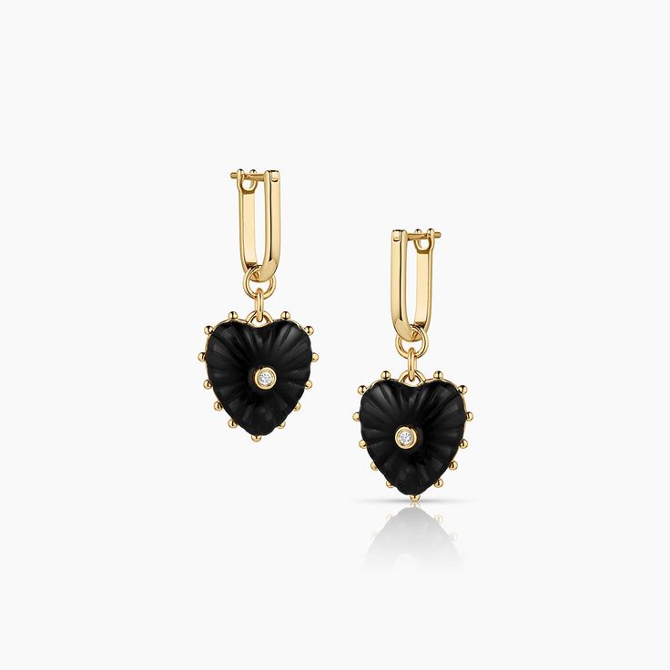 a pair of black and gold earrings