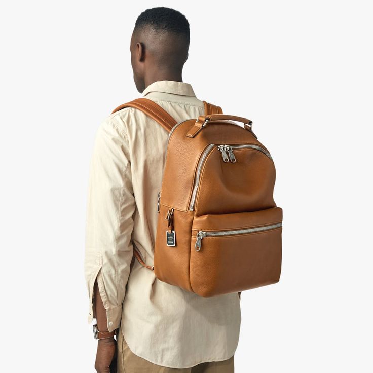 Our flagship leather backpack is thoughtfully designed and built to last. This casual and refined piece in natural grain leather includes adjustable padded shoulder straps, a deluxe top carry handle, and matte-nickel hardware. The premium tan leather is soft to the touch with a natural grain variation that will patina beautifully, adding to its character over time. Head into the office, gym, and weekend without missing a beat—and count on the Runwell Backpack to be in it for the long run. | Shin Modern Backpack With Palladium Hardware For Daily Use, On-the-go Smooth Grain Leather Backpack, Modern Leather Backpack For Daily Use, Luxury Leather Backpack For Everyday, Classic Backpack With Smooth Grain For Everyday Use, Modern Brown Leather Backpack For Everyday Carry, Modern Brown Leather Backpack For Everyday, Modern Brown Leather Backpack, Leather Backpack With Palladium Hardware For Everyday Use