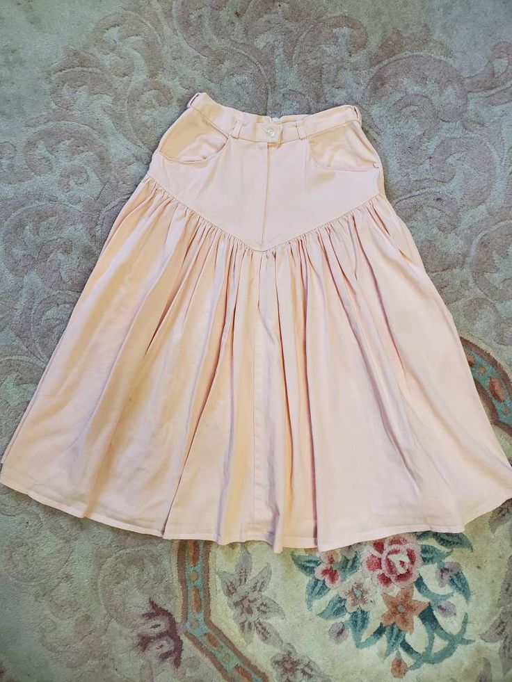 "Amazing handmade skirt probably from the 70's! Peach denim. Western style. Full circle. High-waisted. Midi length. Belt loops, button and zipper in front. Pockets in front. In Excellent Vintage Condition with only small marks (pictured). Measurements: Waist: 28\" Hips: 36\" Length: 31\" Flare: 64\"" Vintage Western Skirt, Retro Fitted Skirt Bottoms, Retro Fitted Skirt, Pink High-waisted Fitted Denim Skirt, Retro High Waist Stretch Skirt, Vintage Cotton Flared Skirt Bottoms, Vintage Cotton Flared Skirt, Vintage High-waist Skirt For Spring, Vintage Long Denim Skirt For Spring