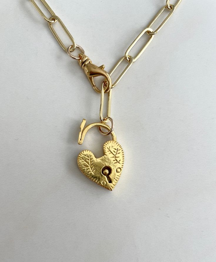 Carry My Necklace. Gorgeous padlock heart. Heart opens so that it can be removed from the chain to give the additional benefit a plain chain necklace. Tarnish Free Material: Gold Filled chain, heart and lobster clasp Necklace length: approximately 18” Each piece is one-of-a-kind. Beautiful variations are not only expected, but celebrated. Chain Heart, Pendant Necklace Gold, Clasp Necklace, Dope Jewelry, Stacked Jewelry, Funky Jewelry, Jewelry Lookbook, The Chain, Layered Jewelry