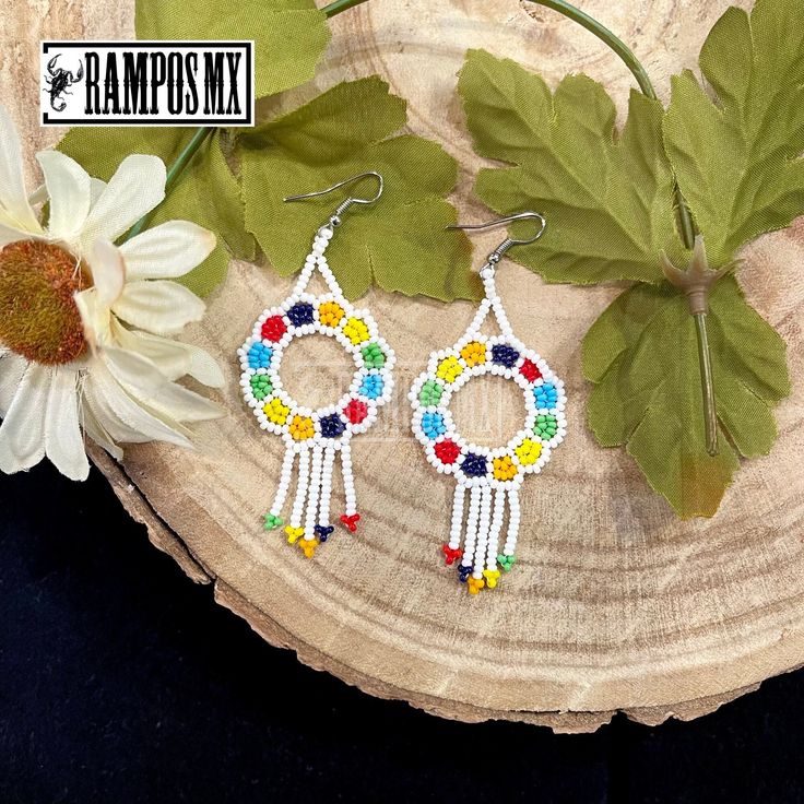 Beautiful Handmade Mexican Earrings , Mexican Shakira Earrings , Bohemian Boho earrings. 100% Handmade Handcraft by great Artisans in Mexico , These lovely Ear Wire earrings are extremely light and can be worn on all everyday occasions specially if you like colorful and fresh accessories. Aprox Size : 3 1/4 inches length & 1 3/8 inch wide Every piece is unique and color might change a little , depending on the screen device its been viewed on Aretes Mexicanos de Shakira , hecho a mano , Arte for Colorful Bohemian Hoop Earrings For Festival, Rainbow Bohemian Beaded Drop Earrings, Multicolor Beaded Flower Earrings For Festivals, Bohemian Rainbow Earrings With Dangling Beads, Multicolor Drop Flower Earrings, Handmade Rainbow Beaded Bohemian Earrings, Bohemian Rainbow Dangle Hoop Earrings, Bohemian Multicolor Flower Earrings With Colorful Beads, Bohemian Rainbow Drop Earrings