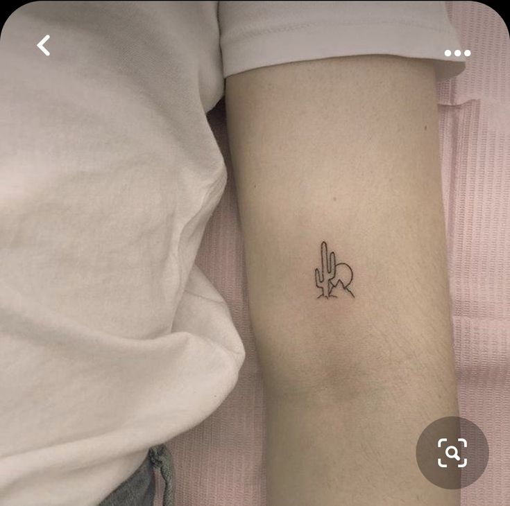 a person with a small tattoo on their arm