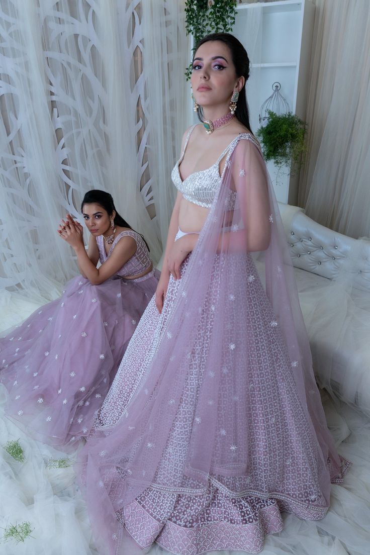 Editor's Note This set features a lilac pearl embroidered crop top paired with a voluminous skirt and dupatta. Fabric: Net Color: Lilac Care: Dry Clean Only Customize Your Outfit Can't find the size you're looking for? No stress. Just select the size "Custom" while adding the item to your cart. We will follow up with you for your body measurements. To request a color or design customizations, please contact our customer care by using our "Ask us a question" form or simply email us. About the Des Lavender Lehenga For Diwali Festive Occasion, Lavender Organza Wedding Set, Lavender Wedding Set With Sheer Dupatta, Festive Lavender Sets With Mirror Work, Party Lehenga With Mirror Work In Lavender, Lavender Lehenga With Mirror Work For Party, Lavender Anarkali Set For Festive Occasions, Party Lavender Lehenga With Mirror Work, Anarkali Lavender Set With Mirror Work