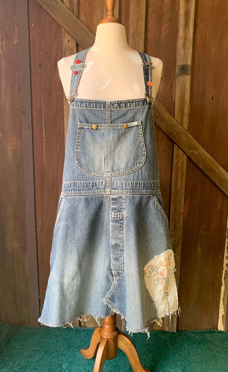 One of a kind upcycled overall dress. Embellished with buttons, vintage linen and stitching Hand and machine stitched with love Measurements: Width @ hips 104cm Side skirt length 48cm Bib to hem 74cm Diy Overalls Into Dress, Upcycle Overalls, Diy Overalls, Summer Occasion Dress, Womens Overalls, Dungaree Dress, Blue Mini Skirt, Jean Dress, Beaded Chiffon