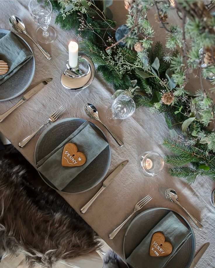 the table is set with silverware and place settings