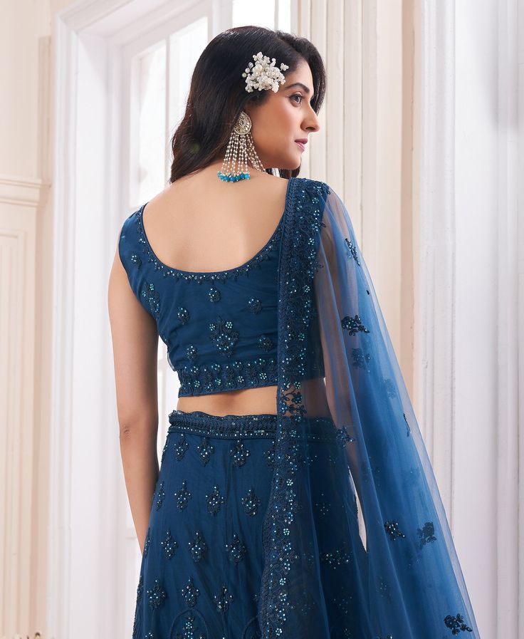 COLOR : Teal Blue FABRIC : Top (Blouse) - Soft Net, Bottom (Lehenga) - Soft Net, Dupatta - Soft Net WORK : Dori, Zarkan, Sequins OCCASION : Wedding, Reception, Mehendi, Engagement READY-TO-WEAR : NoSTITCHING : Available as semi-stitched fabric, can be stitched using standard size option (+$30). Note: There might be a slight color variation due to lighting and flash used during photoshoot. The bright shade seen is the best closer view of fabric's color. Lehenga Designs Simple, Blue Crafts, Heavy Work, Wedding Lehenga, Net Dupatta, Long Skirts, Lehenga Designs, Bridal Lehenga, Blue Fabric