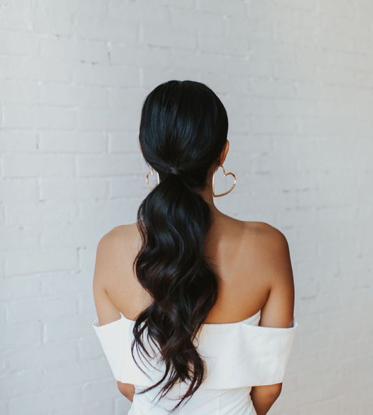 Low ponytail with loose waves Low Pony With Front Pieces, Dark Hair Down Wedding Styles, Low Ponytail With Two Bangs, Low Pony With Headband, Bridal Low Ponytail Hairstyles, Wedding Reception Ponytail, Low Pony With Curls, Bridal Ponytail Dark Hair, Clean Bridesmaid Hair