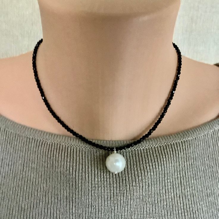 Elegant Look and Style too! Shimmering faceted Onyx beads reflect the light as you move.   And the larger Faux Pearl adds a bit of elegance to the look.  It is relatively light weight and comfortable to wear. The sterling silver Infinity Clasp and extender with a tiny onyx bead at the end make this  a piece that will last. It will make a beautiful gift or a bit of an indulgence for you. This gorgeous necklace will arrive in a ribboned box and is carefully wrapped in another box for shipping. Tha Elegant Faceted Round Bead Crystal Necklaces, Elegant Adjustable Pearl Necklace With Faceted Beads, Elegant Adjustable Faceted Pearl Necklace, Elegant Crystal Necklace With Faceted Beads, Elegant White Faceted Beaded Necklaces, Elegant Onyx Crystal Necklaces With Round Beads, Elegant Onyx Crystal Necklace With Round Beads, Elegant Pearl Crystal Necklaces With Faceted Beads, Elegant Pearl Necklace With Faceted Beads As A Gift