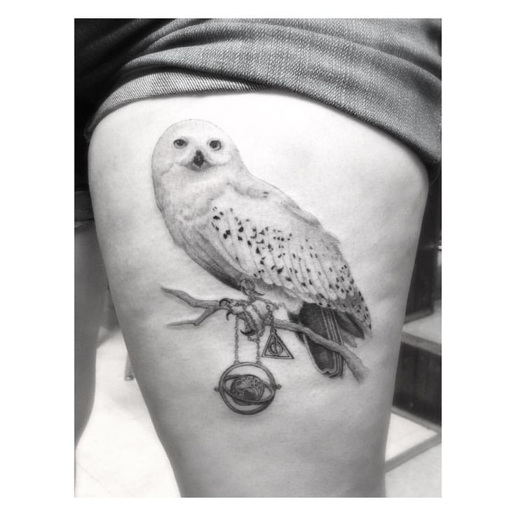 an owl sitting on top of a tree branch next to a clock and key tattoo