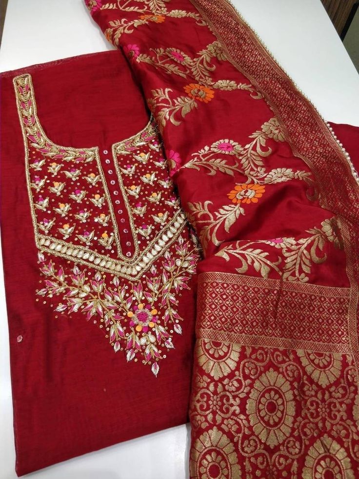 Item Overview ATHARVA Hand Embroidered Salwar Kameez in Red w/Beautiful Embroidered Neck/Beautiful Banarsi Minakari Silk Maroon Dupatta/Customized Stitching/ Wedding/Bridal Trousseau Dno. CH1674 Fabric: * Shirt: Chanderi - Reds- 2.5 Mts, with Beautiful Embroidery Neck * Dupatta: Minakari Banarsi Silk Dupatta (Motifs may wary) * Salwar: Santoon Silk 2.5 Mts. Excusive Hand Embroidered Party Wear Punjabi Suit. Customization: * Fabrics Customization: Designs Can be made in different Fabrics. *Color Festive Raw Silk Salwar Kameez With Intricate Embroidery, Festive Anarkali With Intricate Embroidery, Festive Anarkali Traditional Wear With Intricate Embroidery, Bollywood Traditional Wear With Resham Embroidery, Bollywood Traditional Wear With Resham Embroidery For Designer Wear, Art Silk Anarkali Set With Intricate Embroidery For Diwali, Kundan Churidar With Intricate Embroidery For Wedding, Diwali Dola Silk Anarkali Set With Intricate Embroidery, Intricate Embroidered Dola Silk Anarkali Set For Diwali