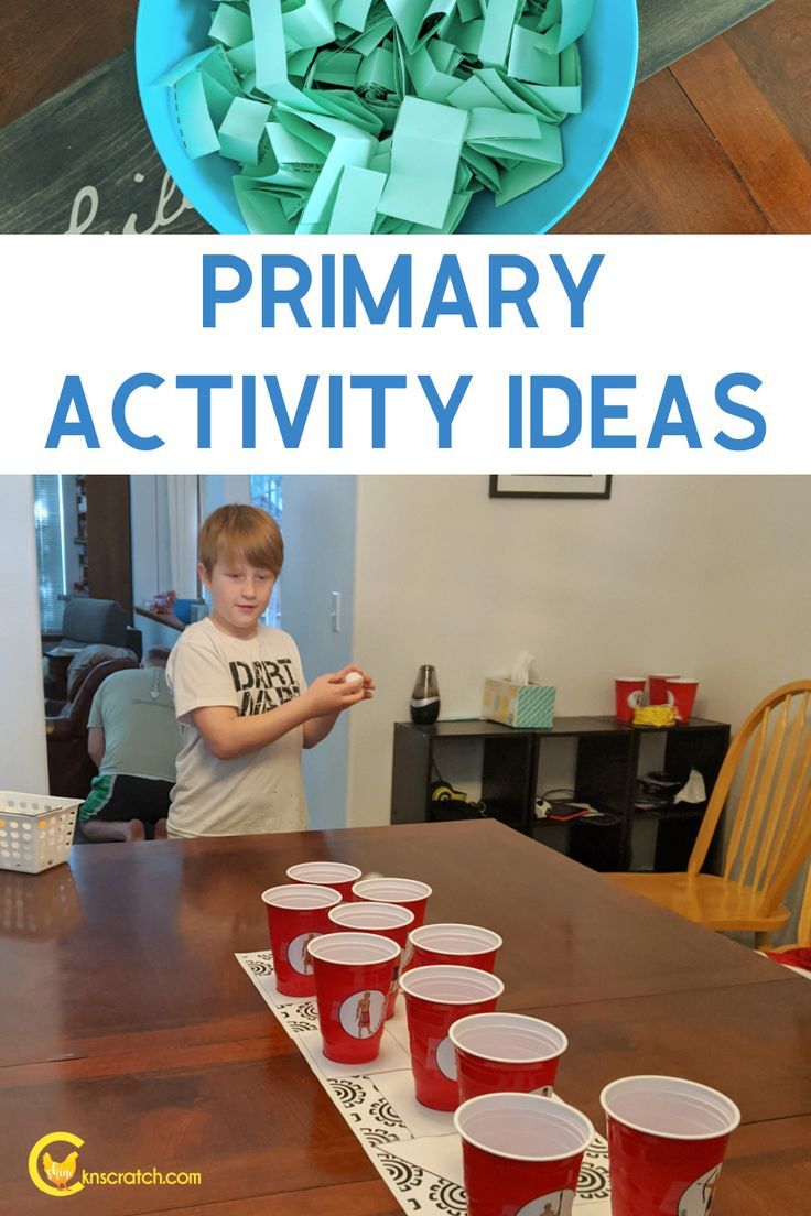 this is an image of a boy playing with paper cups on the table in front of him