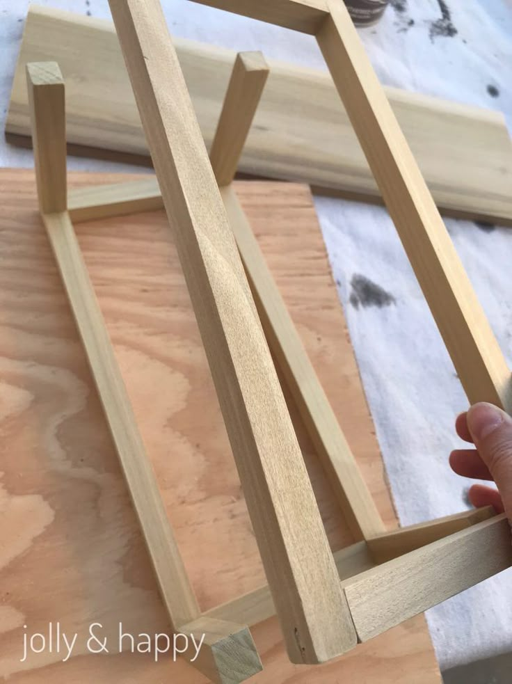 someone is making a wooden frame out of plywood