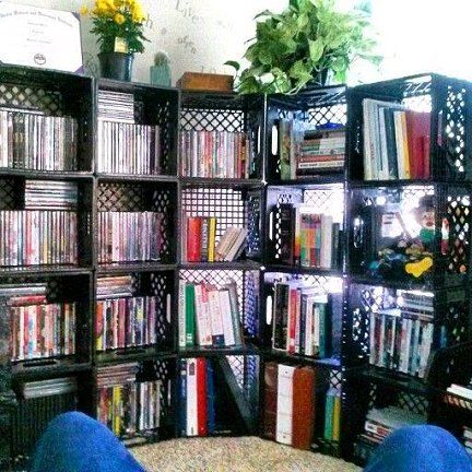 a room with several shelves filled with various types of dvd's