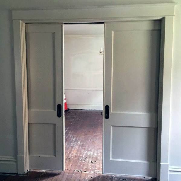 an open door leading to another room with wood flooring and white paint on the walls