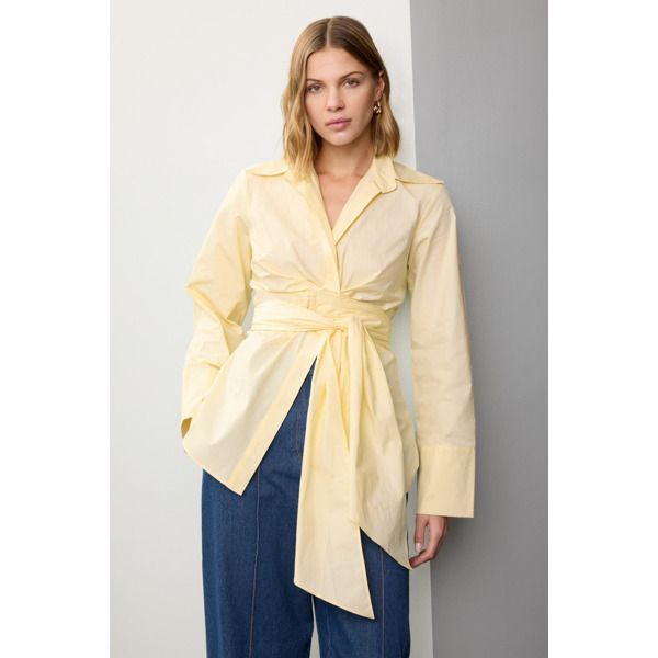 Yellow cotton (100% Cotton). Top. Long sleeves. Collared neckline. Front button closure. 29" from shoulder to hemline. Imported. Cotton Shirt For Spring Daywear, Fall Cotton Blouse With Button Cuffs, Cotton Blouse With Button Cuffs For Fall, Spring Daywear Blouse With Spread Collar, Cotton Tops With Spread Collar For Workwear, Cotton Collared Blouse For Daywear, Cotton Blouse With Button Closure For Daywear, Cotton Blouse With Button Cuffs For Daywear, Chic Cotton Shirt With Spread Collar