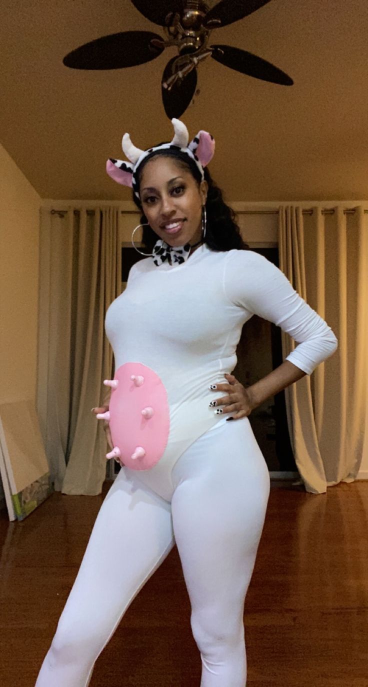 a woman in a white bodysuit with pink doughnuts on her chest and legs